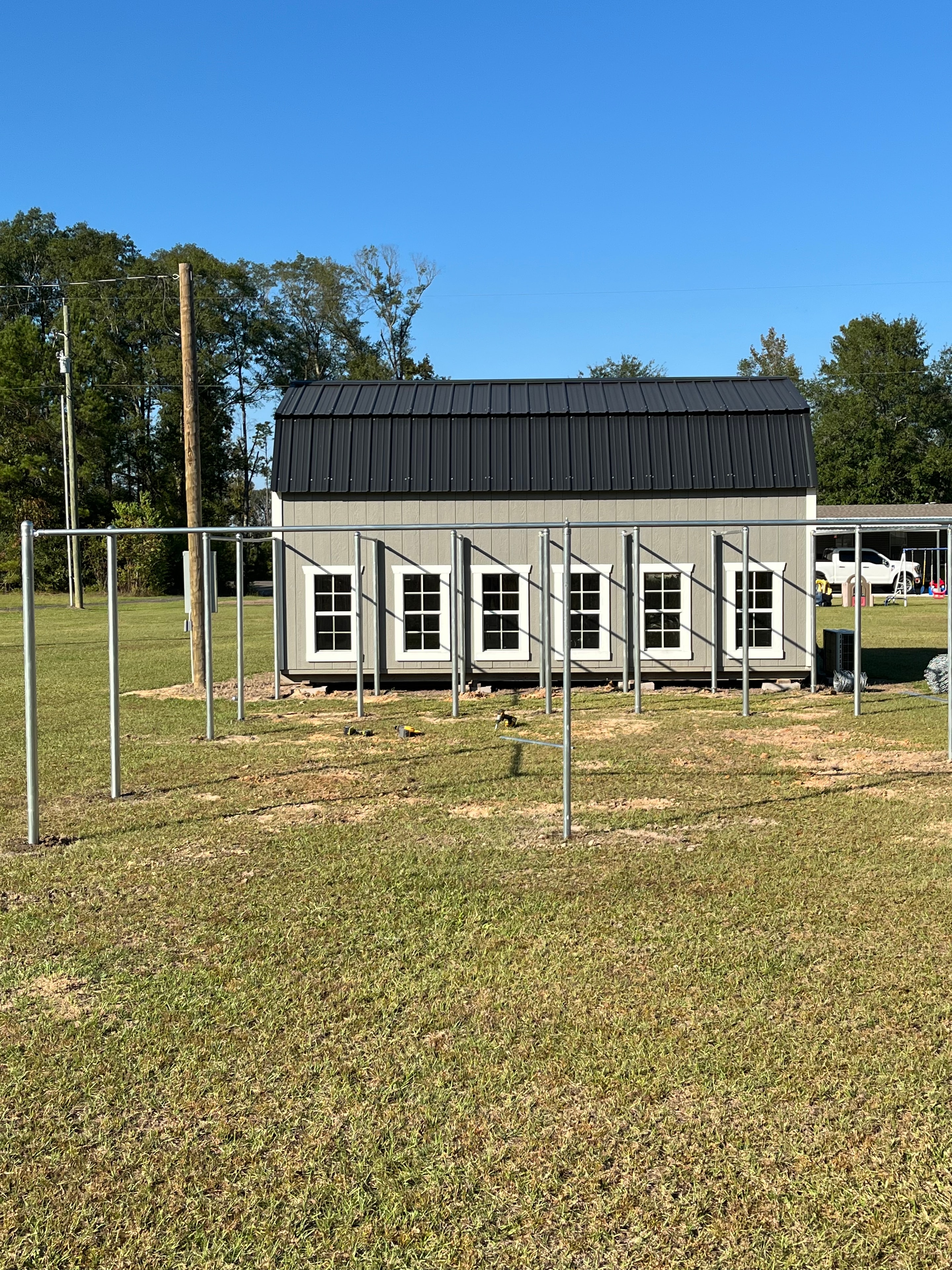 Chain link fence posts being set at new construction multi-unit building in Central Louisiana — Fortified Fence and Weld