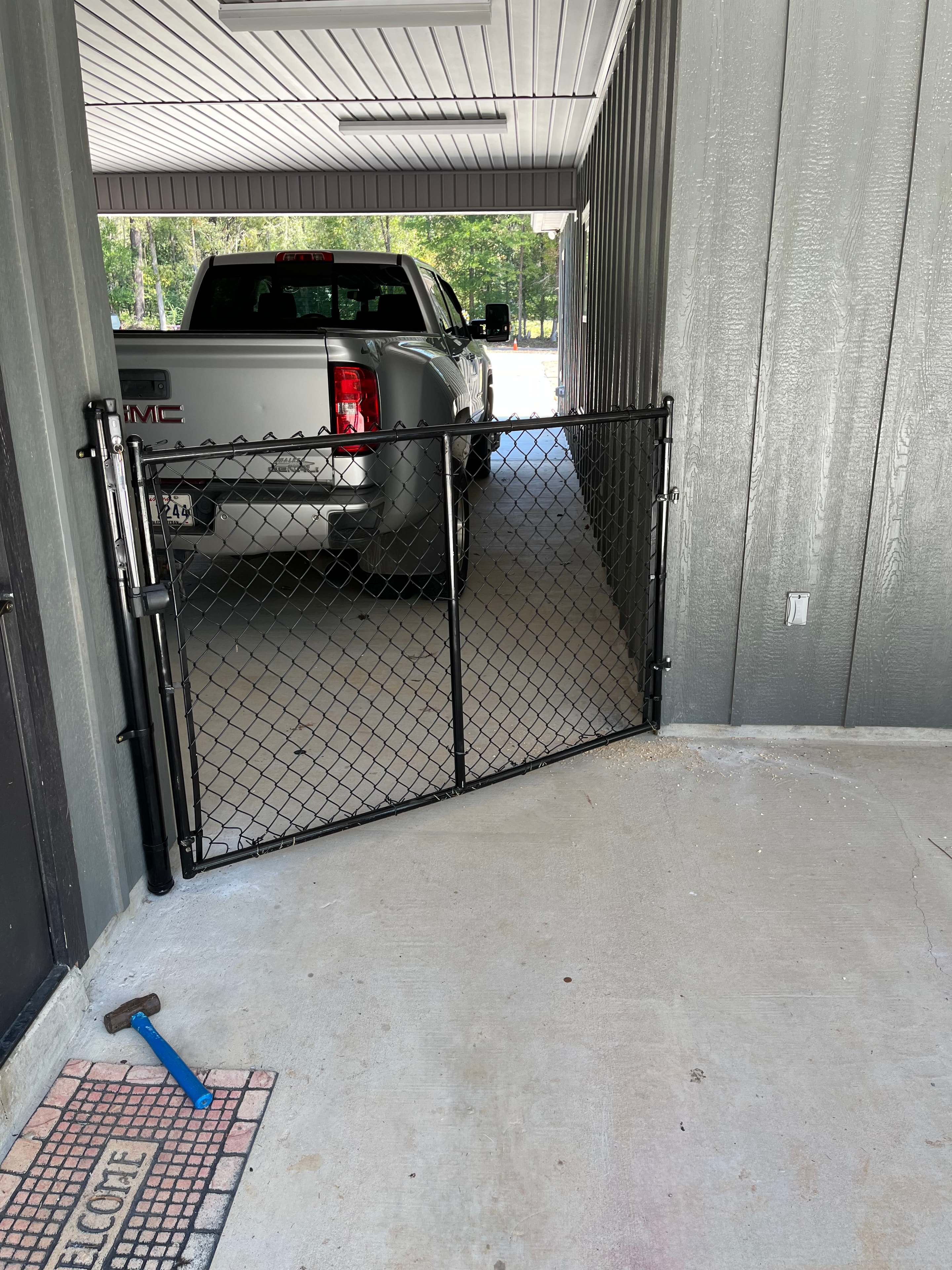 Custom black chain link security gate installed in garage carport opening — Fortified Fence and Weld, Alexandria LA