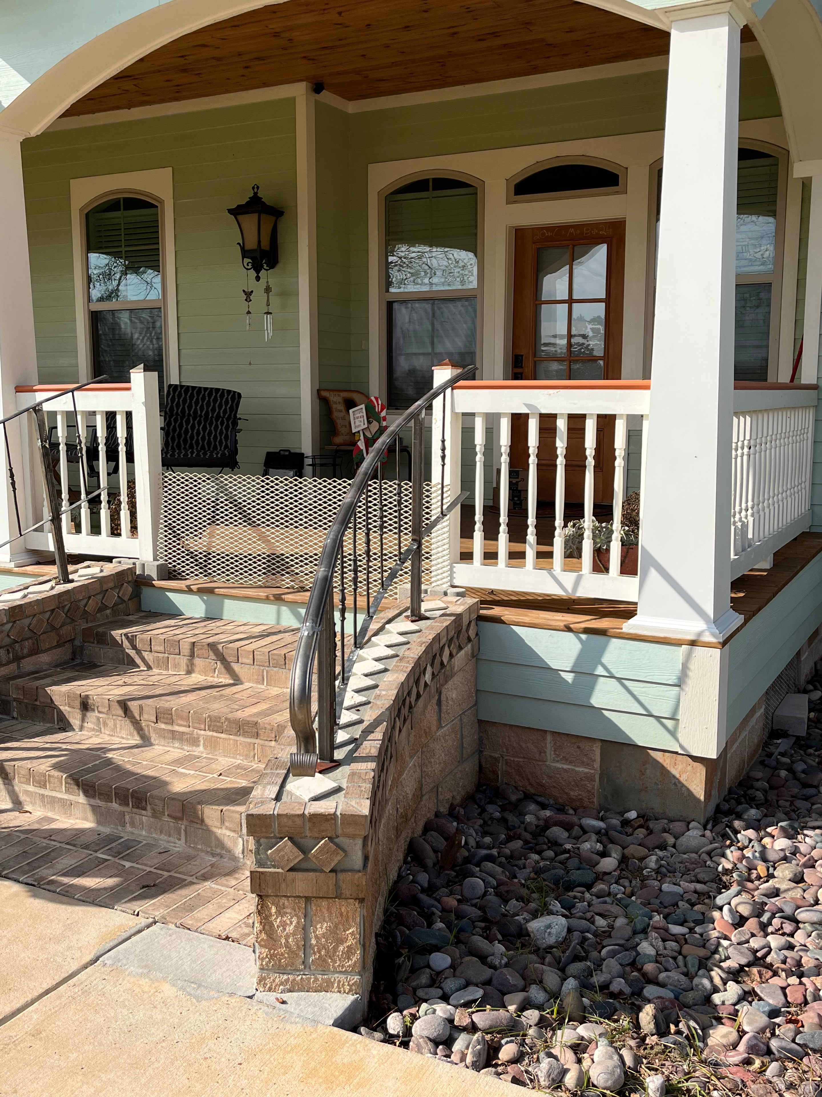 Custom ornamental iron and expanded metal stair railing on decorative brick steps — Fortified Fence and Weld, Alexandria LA