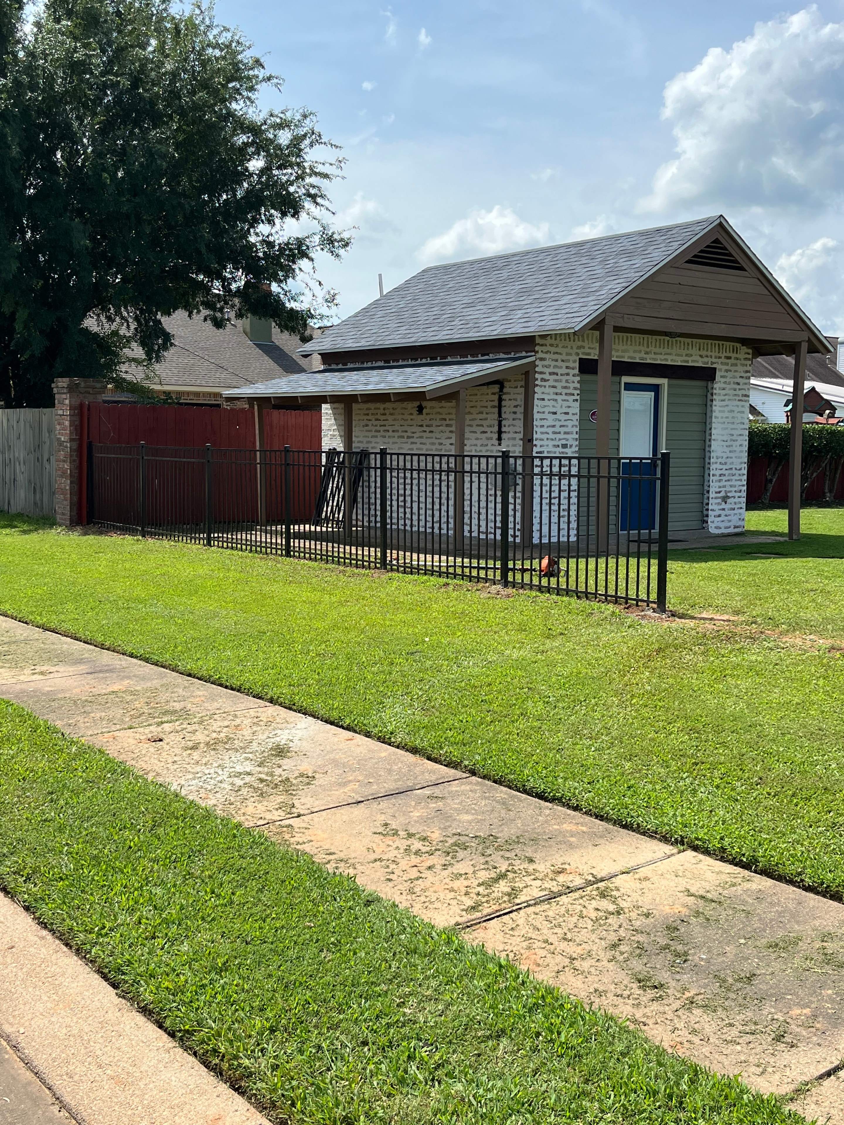 Black ornamental iron fence and staircase railing installed at residential apartment property in Alexandria, LA – Fortified Fence and Weld