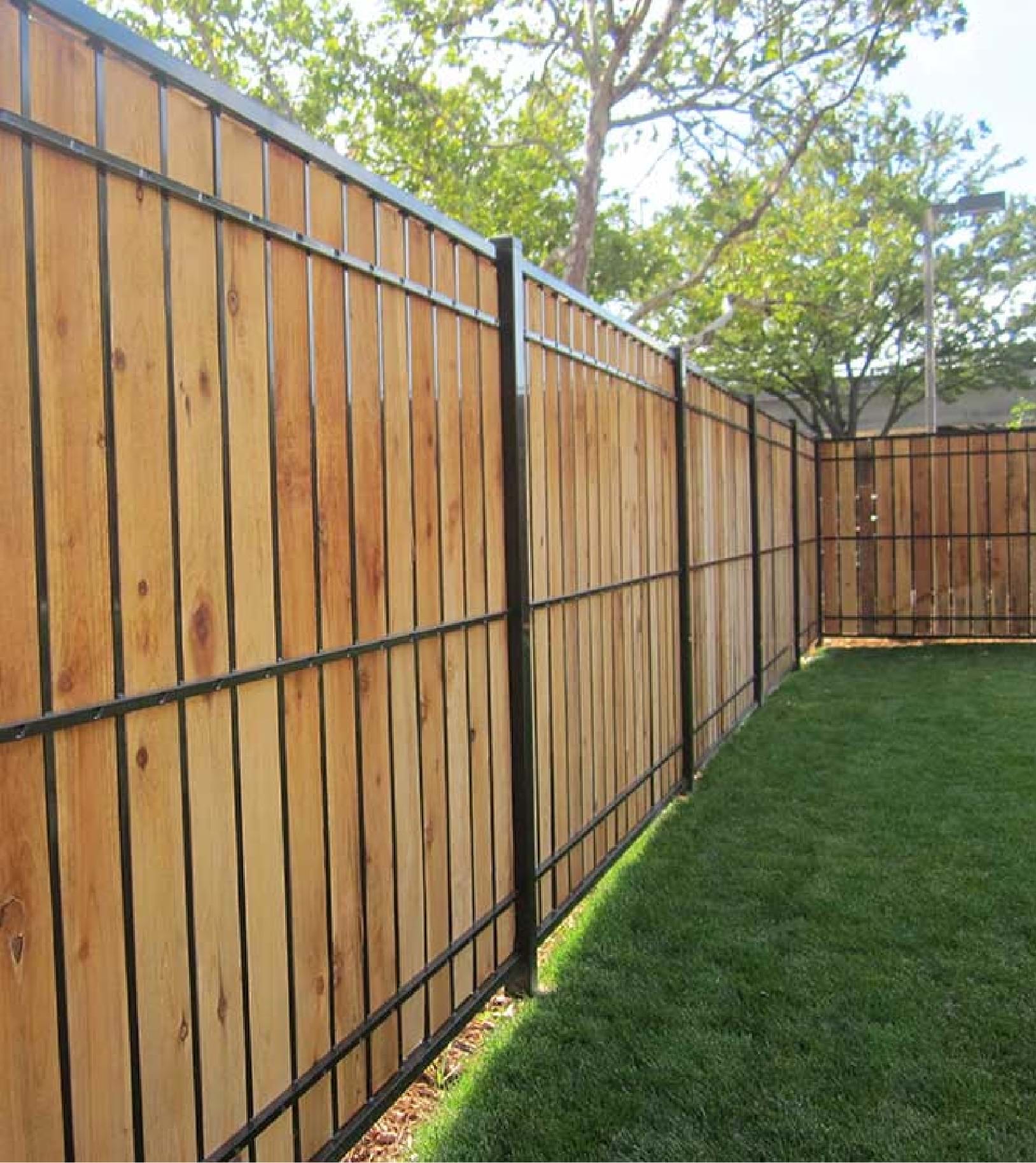 Wood privacy fence with black steel frame and posts — modern residential installation by Fortified Fence and Weld